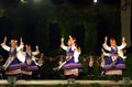Spinning folk female dancers on stage