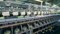 Spinning machines work at textile factory, spooling thread on clews.