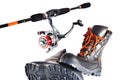 Spinning with a reel and off-road shoes with orange laces on a white background, isolate Royalty Free Stock Photo