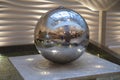 Spinning reflective ball fountain. Water Fountain in the form of a ball