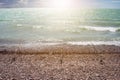 spinning rods standing on the shore of a pebble beach on the sea, waiting for a bite of a large fish in a stormy wind during the