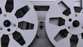 Spinning takeup reel of old analog reel-to reel audio tape recorder. Form of magnetic tape audio recorder in which the