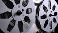 Spinning takeup reel of old analog reel-to reel audio tape recorder. Form of magnetic tape audio recorder in which the