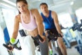 Spinning their way to fitness. A man and woman exercising in spinning class at the gym. Royalty Free Stock Photo