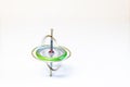 A spinning toy gyroscope isolated on a white background