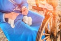 Spinning wheel is a device for manual spinning of one yarn thread. The spinner - woman, engaged in hand-spinning Royalty Free Stock Photo
