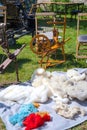 Spinning wheel and equipment on the open air. Yarn, wool, thread. Royalty Free Stock Photo