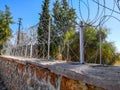 Spiral barbed wire fence on a brick wall