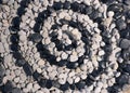 Spiral of black and white pebbles Royalty Free Stock Photo