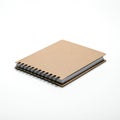 Spiral-bound notebook with a brown cardboard cover, positioned on a white surface. Royalty Free Stock Photo