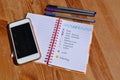 Bullet journal, pens and cellphone on desktop Royalty Free Stock Photo