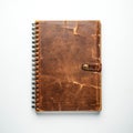 Spiral-bound notebook features a distressed brown leather cover with a visible leather Royalty Free Stock Photo