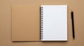 Spiral-bound notebook open on a brown background. Left side features a blank Royalty Free Stock Photo