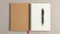Capped pen is placed vertically on the white page. Notebook has a red Royalty Free Stock Photo