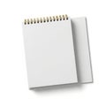 Spiral-bound notebook resting next to a blank notepad on a plain surface Royalty Free Stock Photo