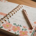 Spiral-bound planner featuring a pink floral design at the bottom. The open page Royalty Free Stock Photo