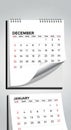 Spiral-bound wall calendar displaying December and January. December page shows Royalty Free Stock Photo