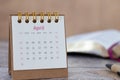 Spiral calendar with dates of month April and pen with open holy bible book in the background Royalty Free Stock Photo