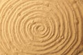 Spiral drawing on beach sand background. Royalty Free Stock Photo