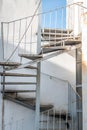 Spiral industrail metal stairs and a building Royalty Free Stock Photo