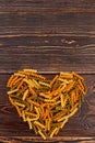 Spiral macaroni forming heart shape. Royalty Free Stock Photo