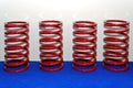 Spiral metal red springs on blue podium and white background