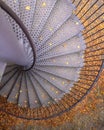 Spiral metal staircase with fallen autumn leaves