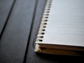 Blank spiral note pad, paper on rugged black background. Royalty Free Stock Photo