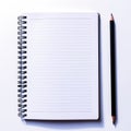 A spiral notebook with a black pencil on a white surface.