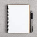 Spiral Notebook with Blank White Pages and Pen on Grey Textured Surface Royalty Free Stock Photo