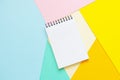 Spiral notebook with blank white sheet on multi-colored paper Royalty Free Stock Photo