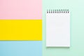 Spiral notebook with blank white sheet on multi-colored paper. Royalty Free Stock Photo