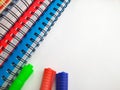 Spiral notebook with markers pens. Stack of colorful notebooks isolated on white background.Colored - blue, red,green, white. Royalty Free Stock Photo