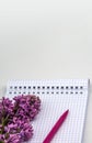 Spiral notebook and pen. Notepad with pen and flowers. Notebook lilacs on white background Royalty Free Stock Photo