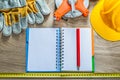 Spiral notebook pencil protective gloves measuring tape building Royalty Free Stock Photo