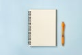 Spiral Notebook or Spring Notebook and Orange Pen on Pastel Minimalist Background Royalty Free Stock Photo