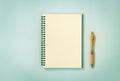 Spiral Notebook or Spring Notebook and Orange Pen on Pastel Minimalist Background in Vintage Tone Royalty Free Stock Photo