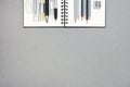 Spiral notebook and various drawing tools on gray recycled paper Royalty Free Stock Photo