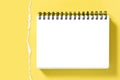 Spiral notepad book mockup torn paper border Yellow background