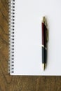 Spiral notepad, pen on wooden desk Royalty Free Stock Photo