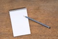 Spiral Notepad and Pencil on a wooden table