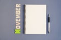 Spiral open notebook with pen and November month wording