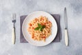 Spiral pasta mixed with cherry tomatoes and tomato sauce on a plate Royalty Free Stock Photo