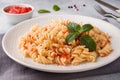 Spiral pasta mixed with cherry tomatoes and tomato sauce on a plate Royalty Free Stock Photo