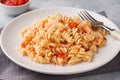Spiral pasta mixed with cherry tomatoes and tomato sauce on a plate Royalty Free Stock Photo