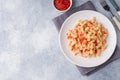 Spiral pasta mixed with cherry tomatoes and tomato sauce on a plate. Copy space Royalty Free Stock Photo