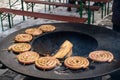 Spiral-rolled sausages ready to eat, grilled or roasted in a barbecue on an open fire and flames Royalty Free Stock Photo