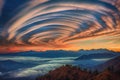 spiral-shaped clouds swirling over a mountain range