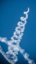 Spiral smoke on blue sky Airplane outline air show Royalty Free Stock Photo