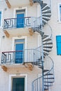 Spiral stair leading to blue doors